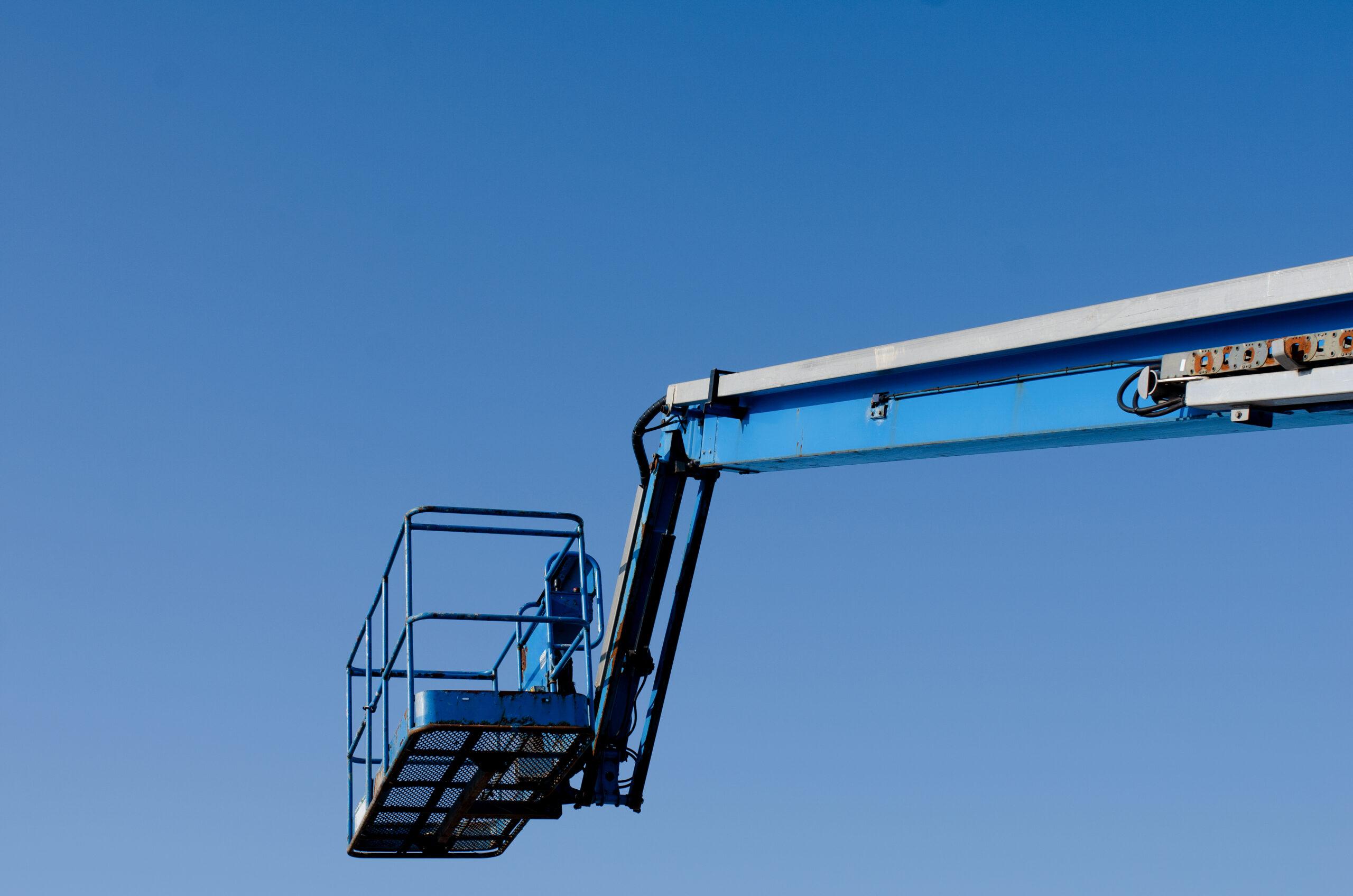 Sky blue area work platform lift in the sky.